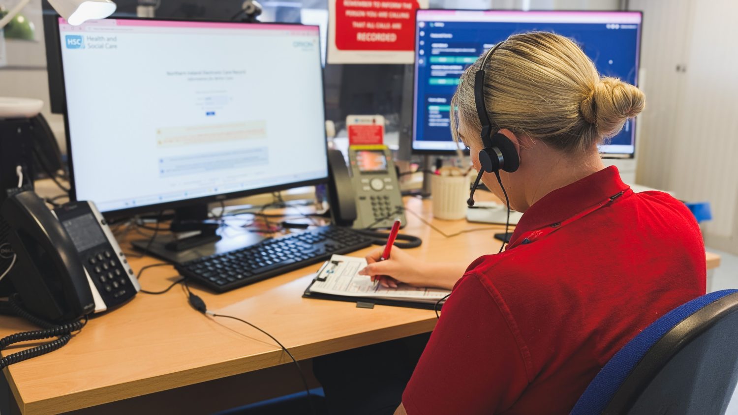 NISTAR Call handler sat at desk taking a phone referral