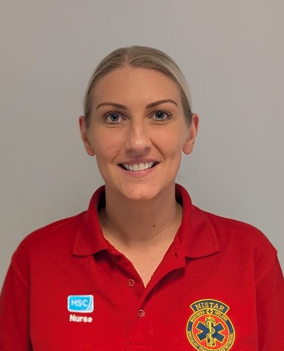 Headshot photo of Jenny Thompson standing against a white wall