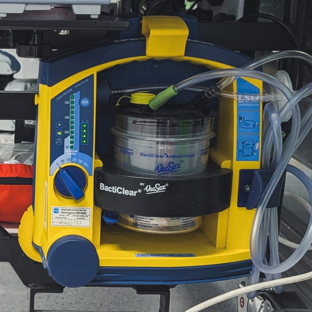 Laerdal Suction Machine on bracket at the end of paediatric transport trolley