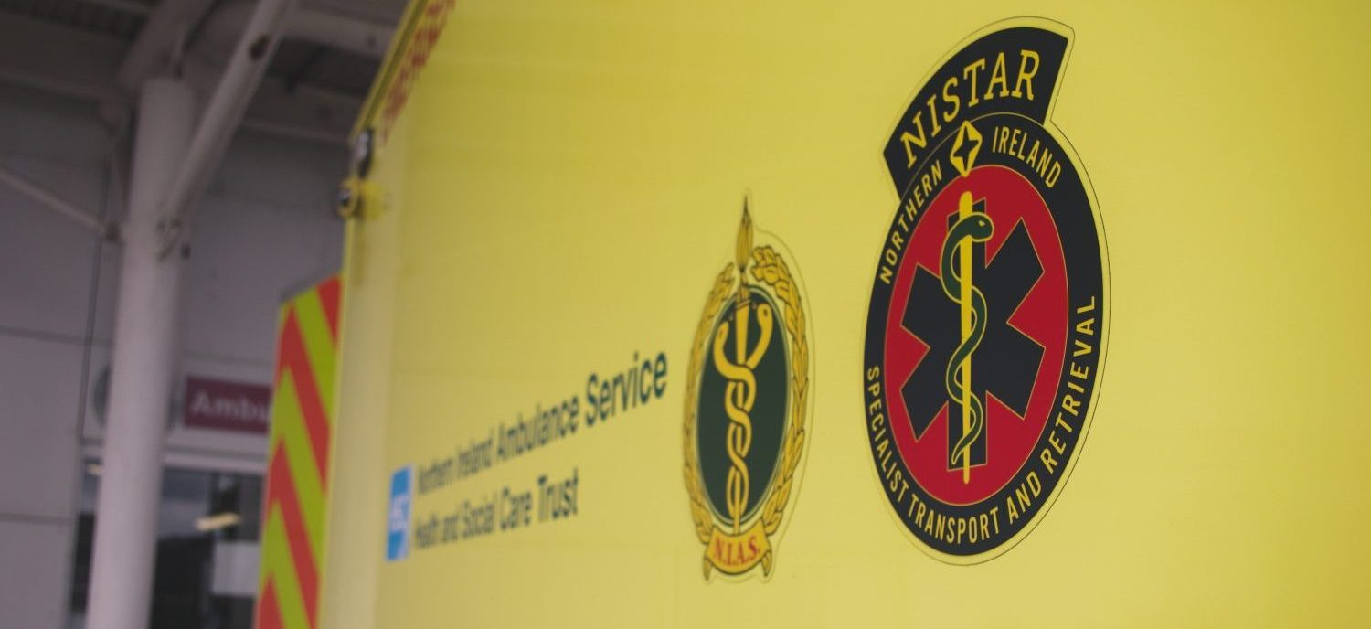 Up close photo of side of NISTAR ambulance with NISTAR and NIAS logo