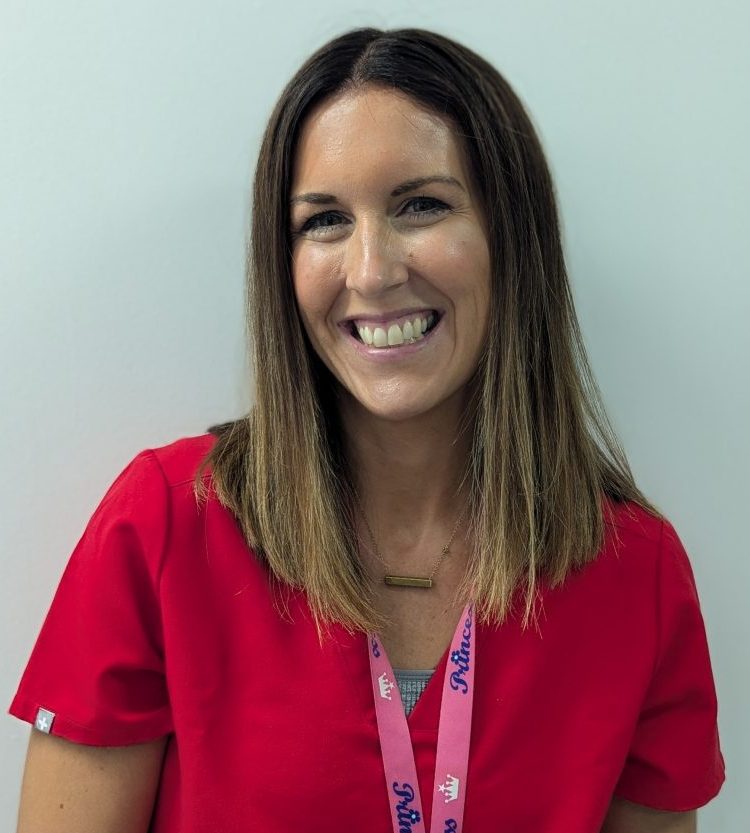 Headshot of Seana Molloy standing against a white wall