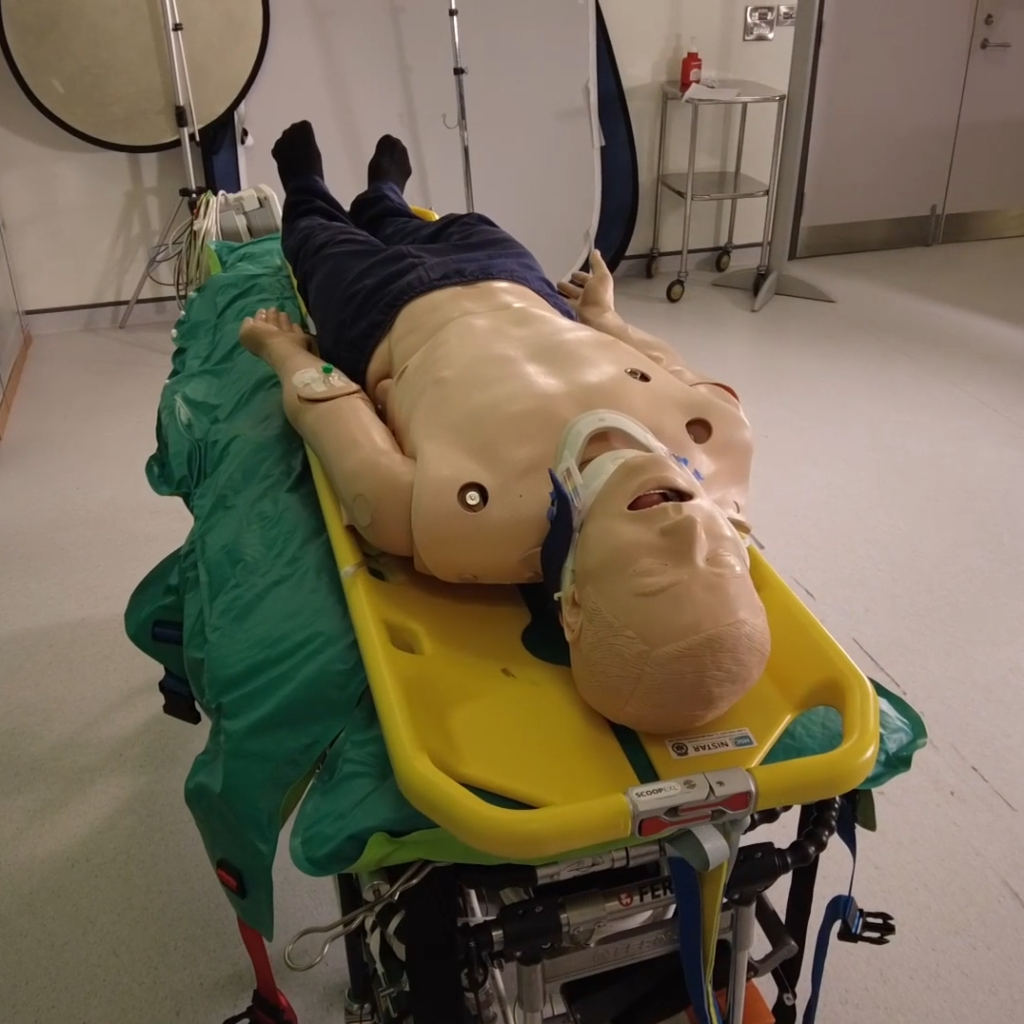 Mannequin on top of Vacuum mattress and scoop slide in a demonstration of how to use it